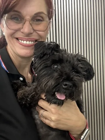 Mia Lompar, founder of Pawmetto Stay & Play, with one of her guests